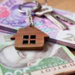 Real estate investing concept. Ukrainian hryvnia, cash or housing. Keys close up