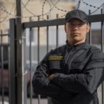 Охрана промышленных объектов от Security Corporation portrait-of-male-security-guard-with-barbed-wire-fence-scaled